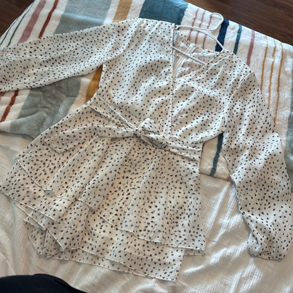 Cream romper with brown design.
